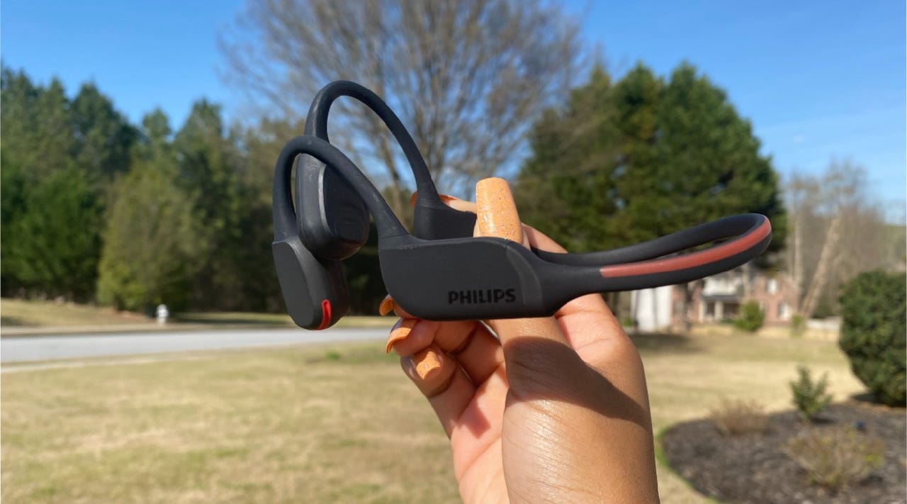 photo of someone holding the Philips A7607 bone conduction headphones