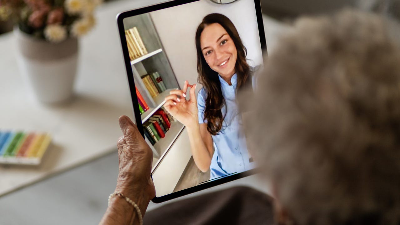 Caretaker giving instructions to a patient over a video call