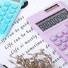 Light blue and light purple calculators on top of a book
