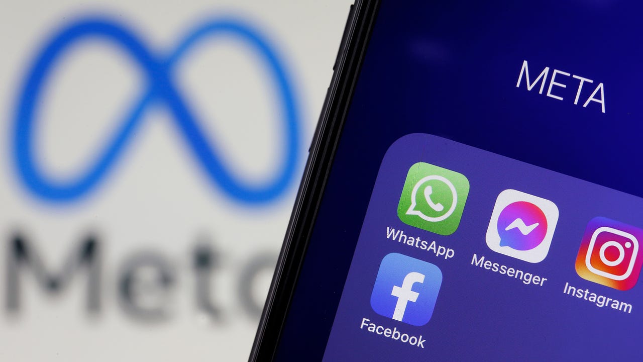 PARIS, FRANCE - FEBRUARY 03: In this photo illustration, The logos of applications, WhatsApp, Messenger, Instagram and facebook belonging to the company Meta are displayed on the screen of an iPhone in front of a Meta logo on February 03, 2022 in Paris, France. Share prices for Facebook's parent company, Meta, slumped in after-hours trading after the company reported that social network's daily active users declined to 1.929 billion in Q4 of 2021 from 1.930 billion in the previous quarter. Facebook is losing users for the first time in its history, Mark Zuckerberg's company has seen its profits decline, and the transition to the metaverse promises to be chaotic. (Photo illustration by Chesnot/Getty Images)