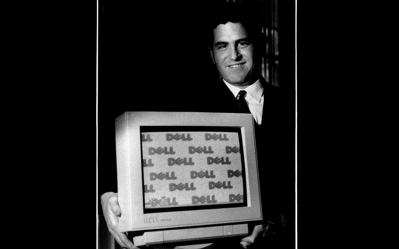 Michael Dell holding a Dell computer monitor in 1993