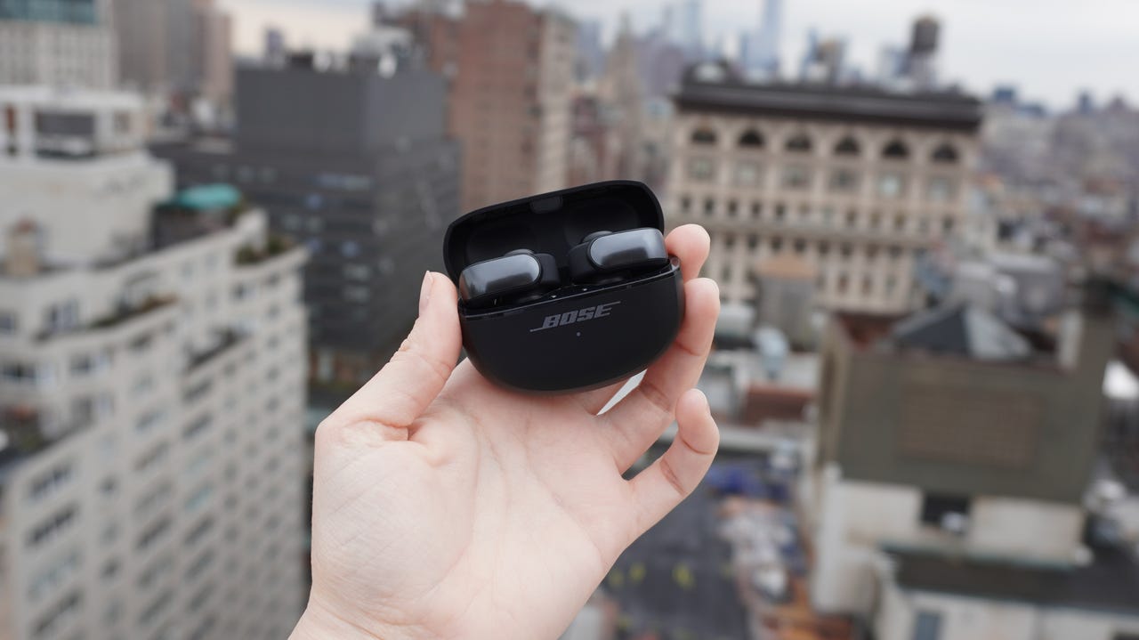 Bose Ultra Open Earbuds against city scape