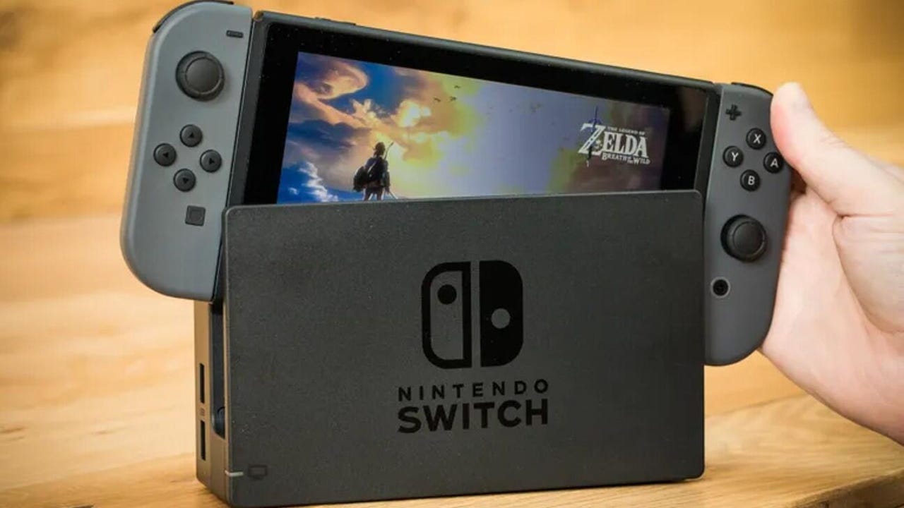 A Nintendo Switch being placed in its dock with Zelda: Breath of the Wild playing on it