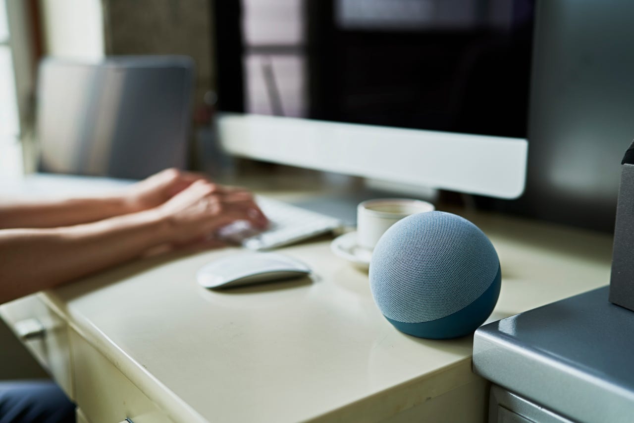 Working from home and Using a smart speaker - stock photo