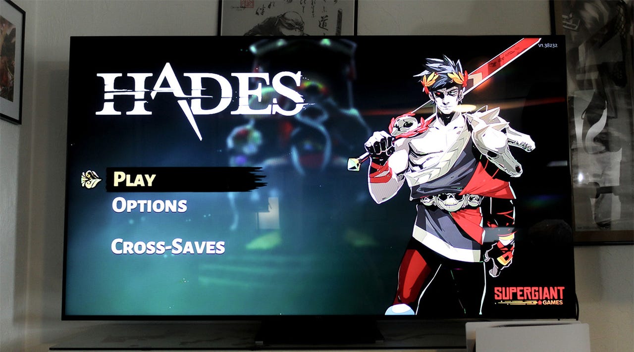 A TCL QM8 TV showing the start screen for the game Hades