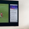 A man watching a soccer match on a Samsung Q60B