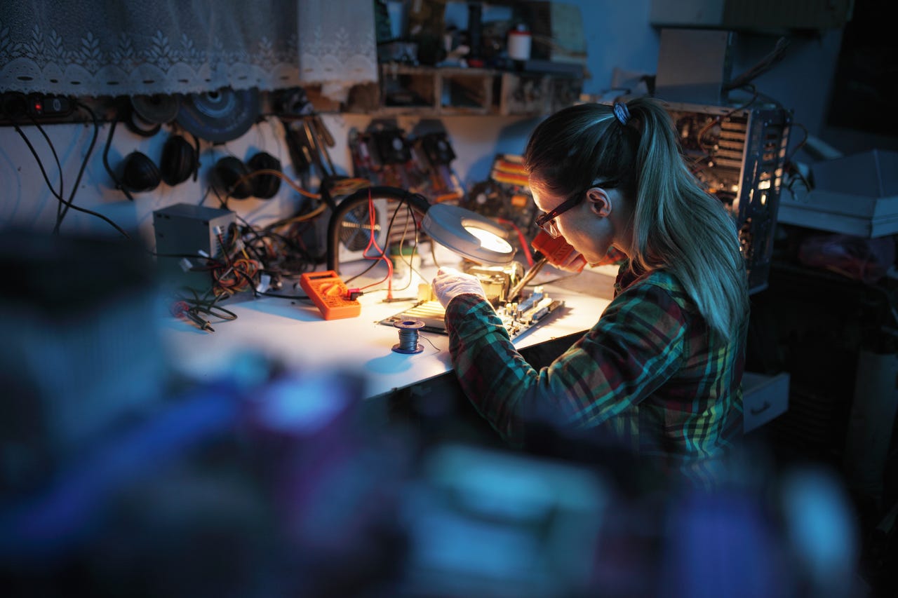 Woman soldering at a table