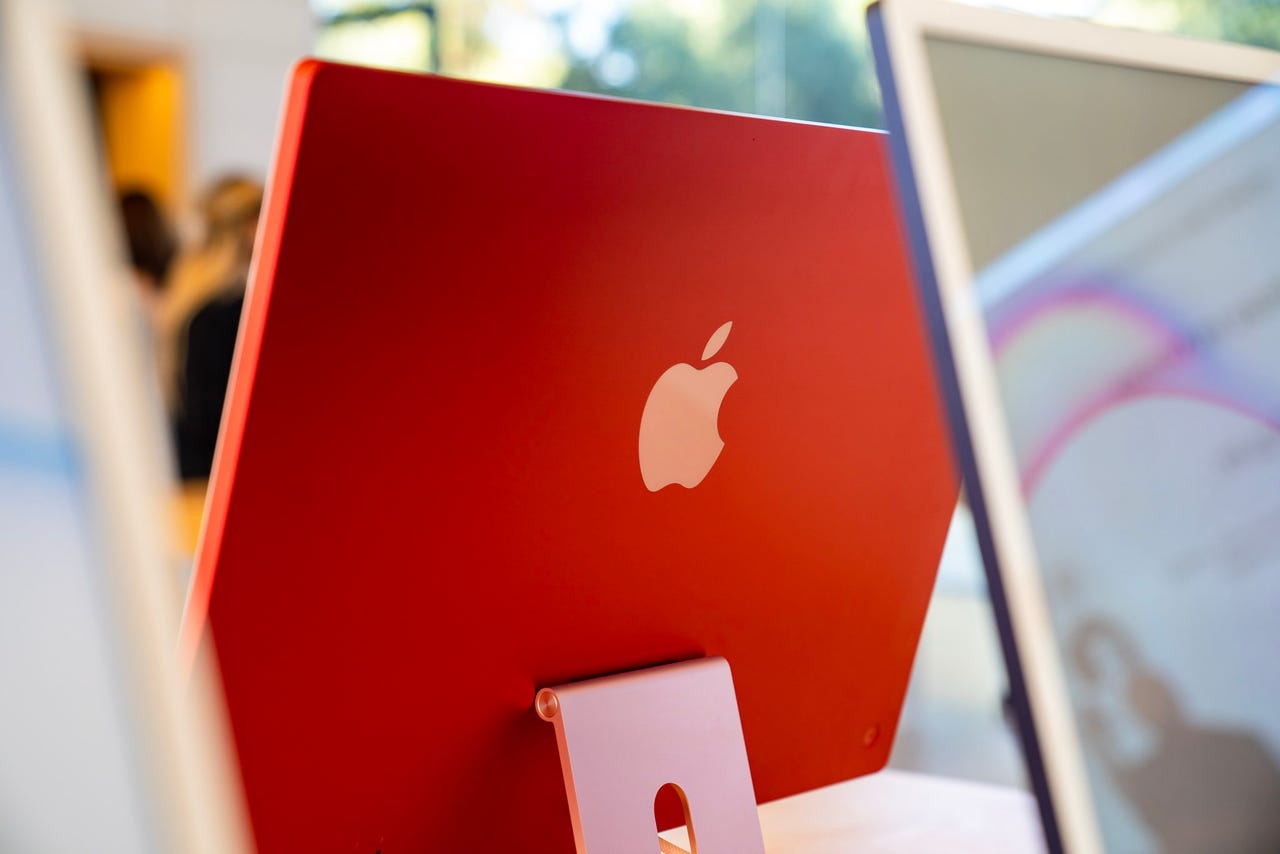 A red 24-inch iMac at the Apple store.
