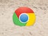 Chrome logo in sand.