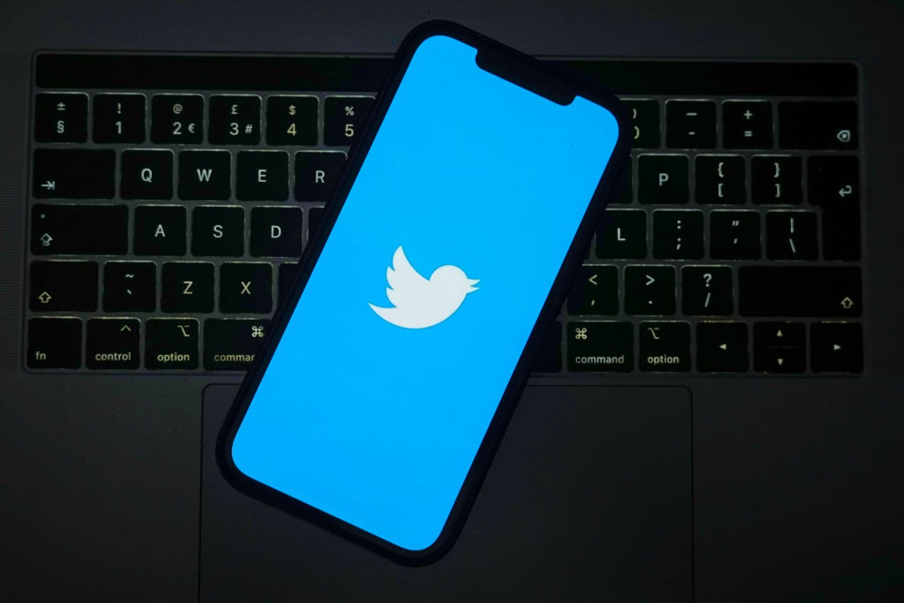 Twitter logo on phone that is on a keyboard