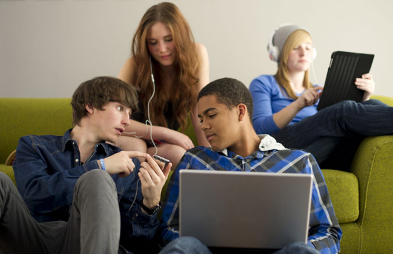 students-watching-tv-computer-couch-stock-620x400