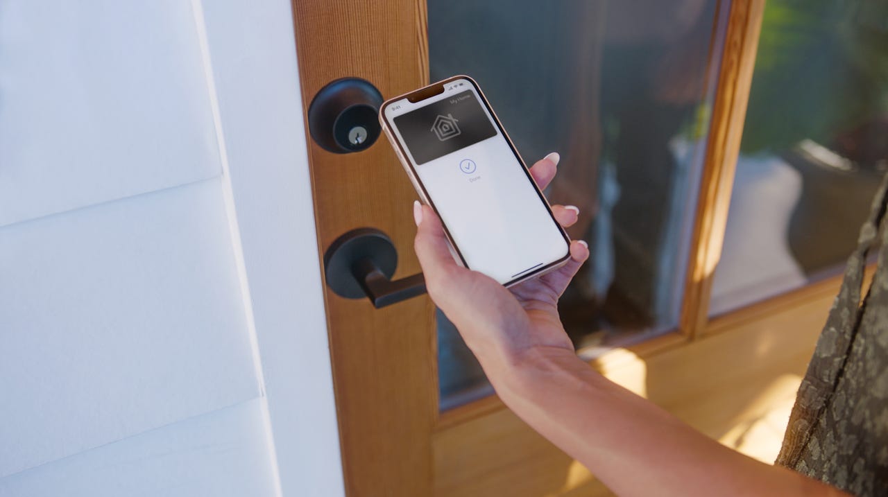 Using a lock app on a phone in front of a closed door