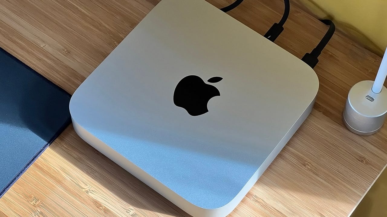An M2 Mac Mini on a desk with other accessories