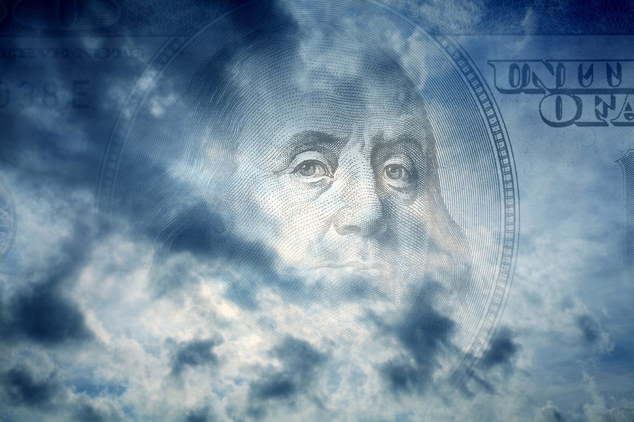 Conceptual image of one hundred US dollar bill in cloudy sky