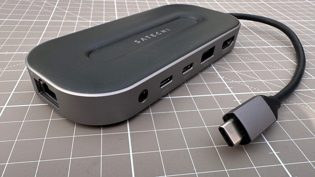 Satechi USB-4 Multiport with 2.5 Ethernet on a gridded surface.