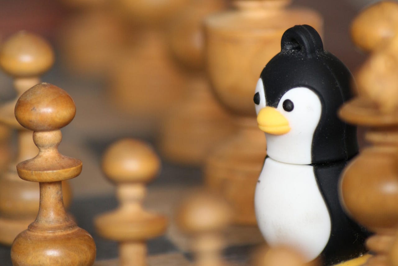 Closeup of Linux penguin on chess board