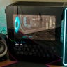 Close-up of the Alienware Aurora R16 tower next to a speaker and monitor.