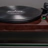 A dark wooden record player with a record on it