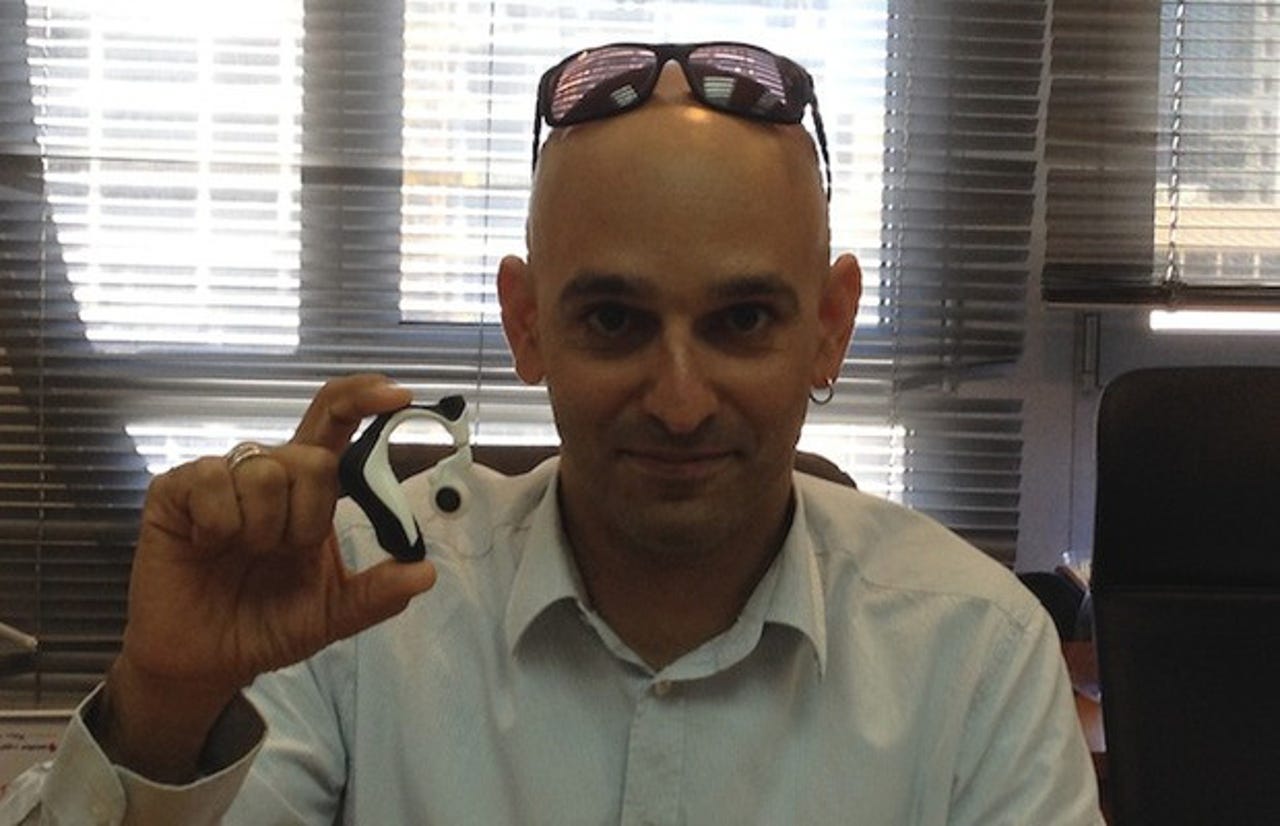 Ronen Sofer, director of Intel's Herzliya development center, holds up an earpiece containing Jarvis technology. The Herzliya center was 'involved' in the development of Jarvis, Sofer said
