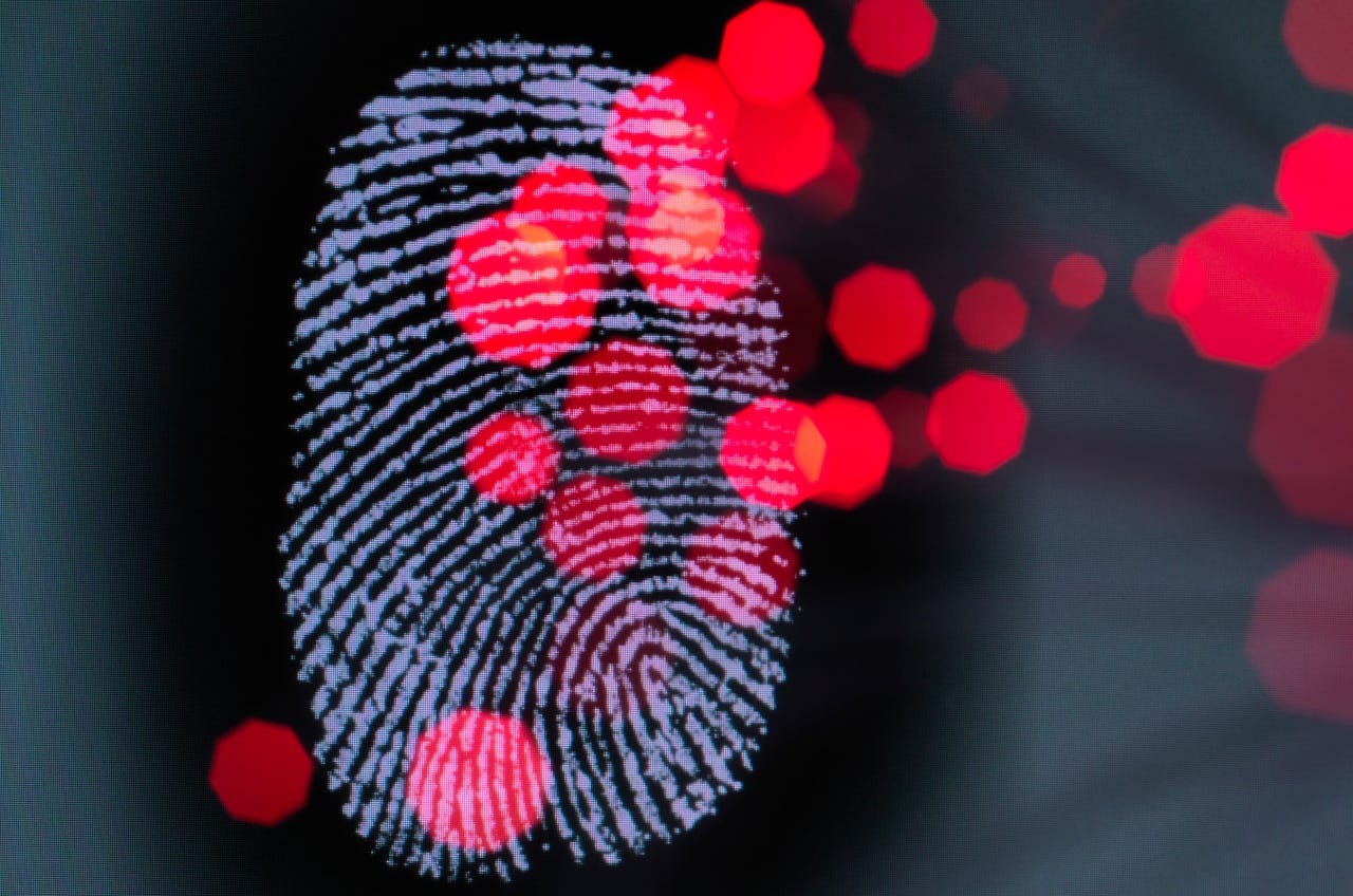 Data infecting a finger print identity on a screen to illustrate hacking and cyber crime.