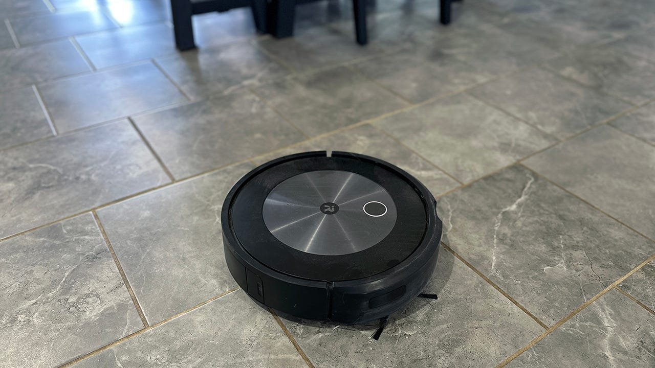 Roomba j7+ vacuuming on tile.