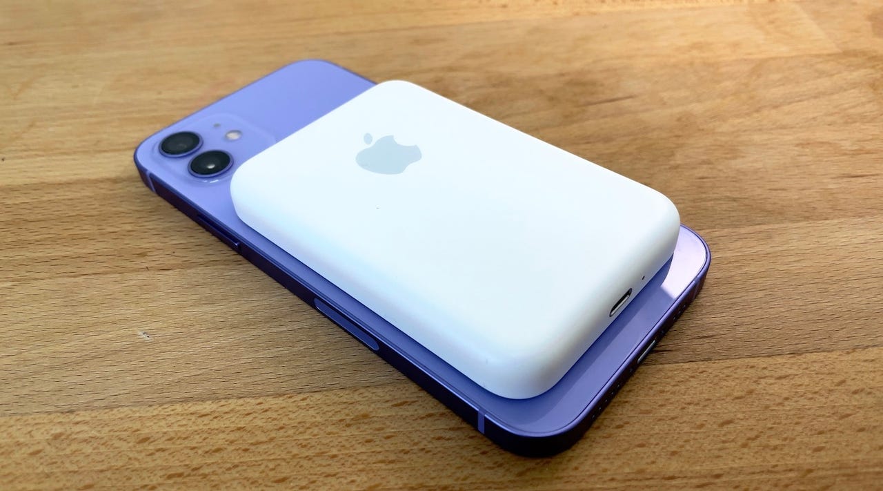 Purple iPhone with a white MagSafe battery back on its back