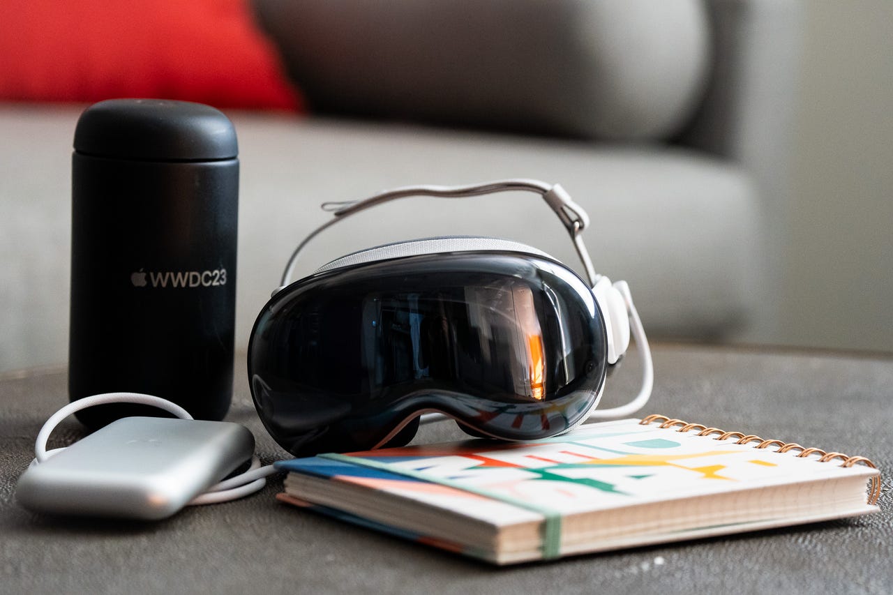 Vision Pro with notebook and WWDC23 water bottle