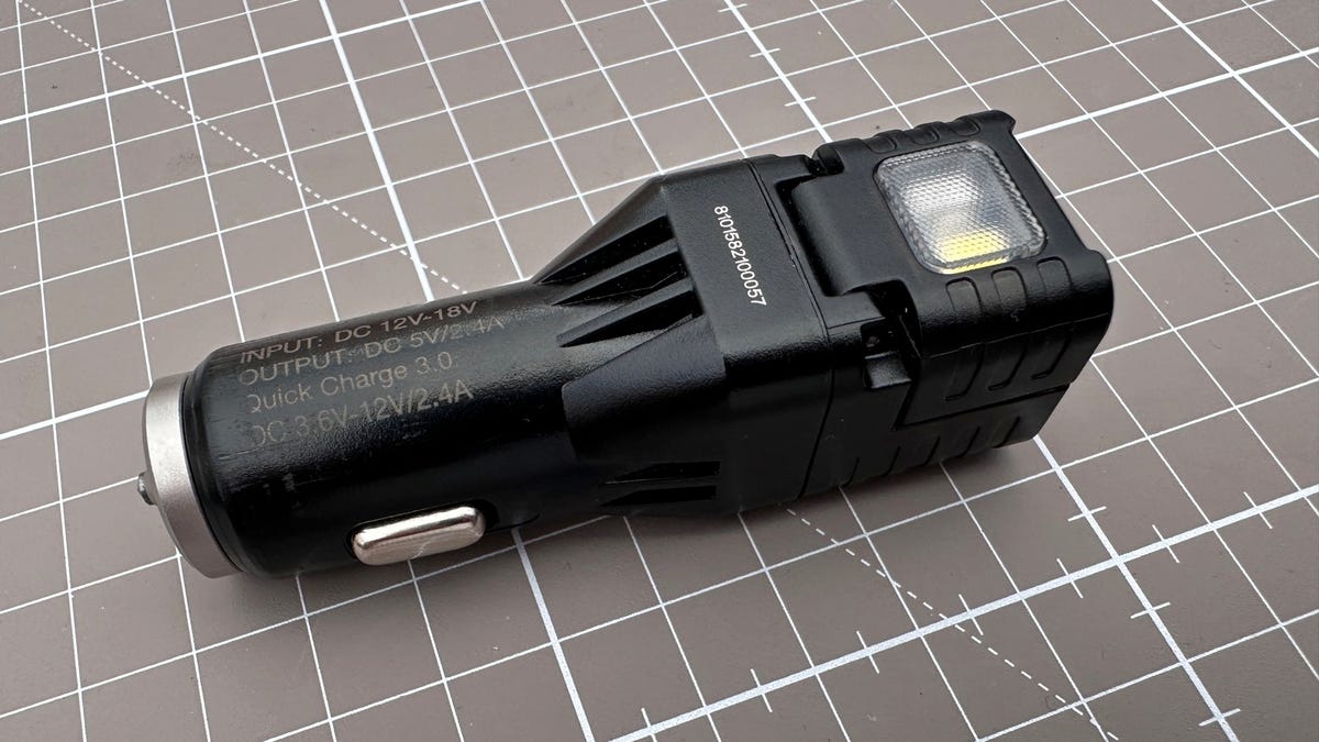 Nitecore VCL10 car charger on brown background.