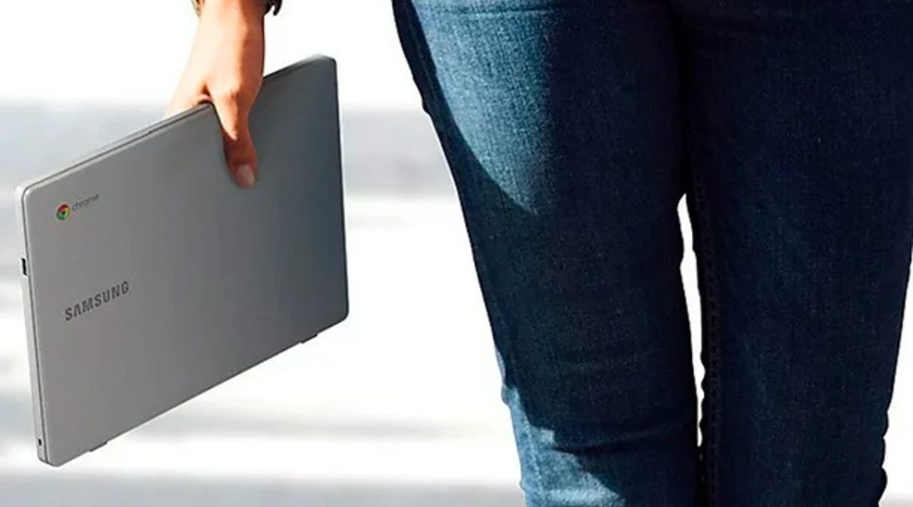 Person holding Samsung 11.6" 720p Chromebook in hand