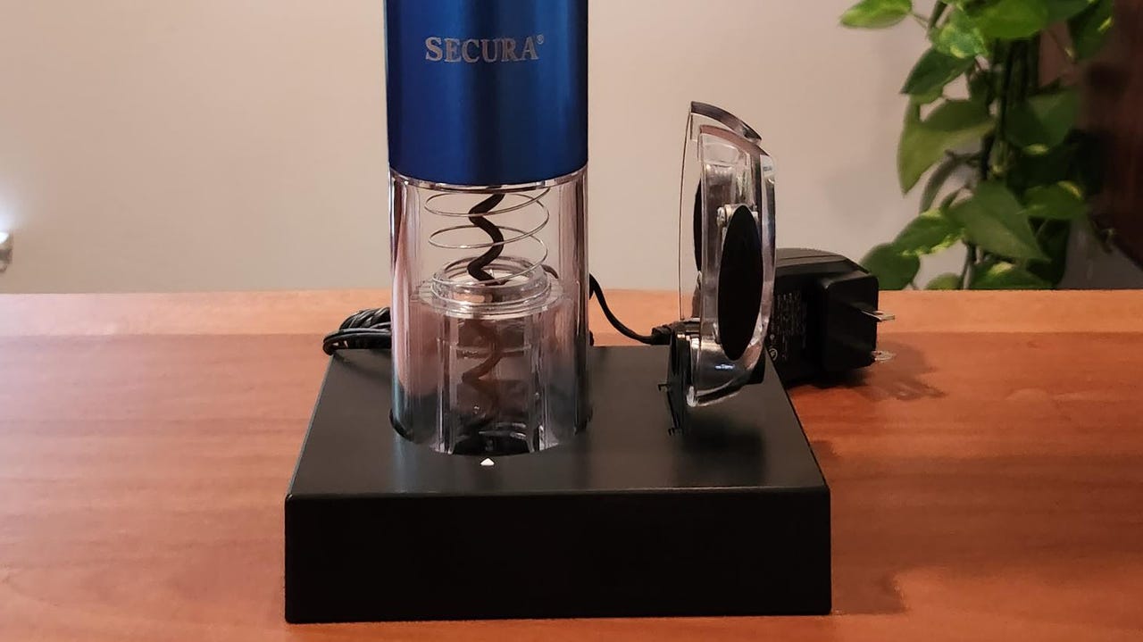 Secura electric corkscrew on a table near a plant