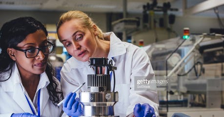 two female medical engineers looking at a piece of equipment