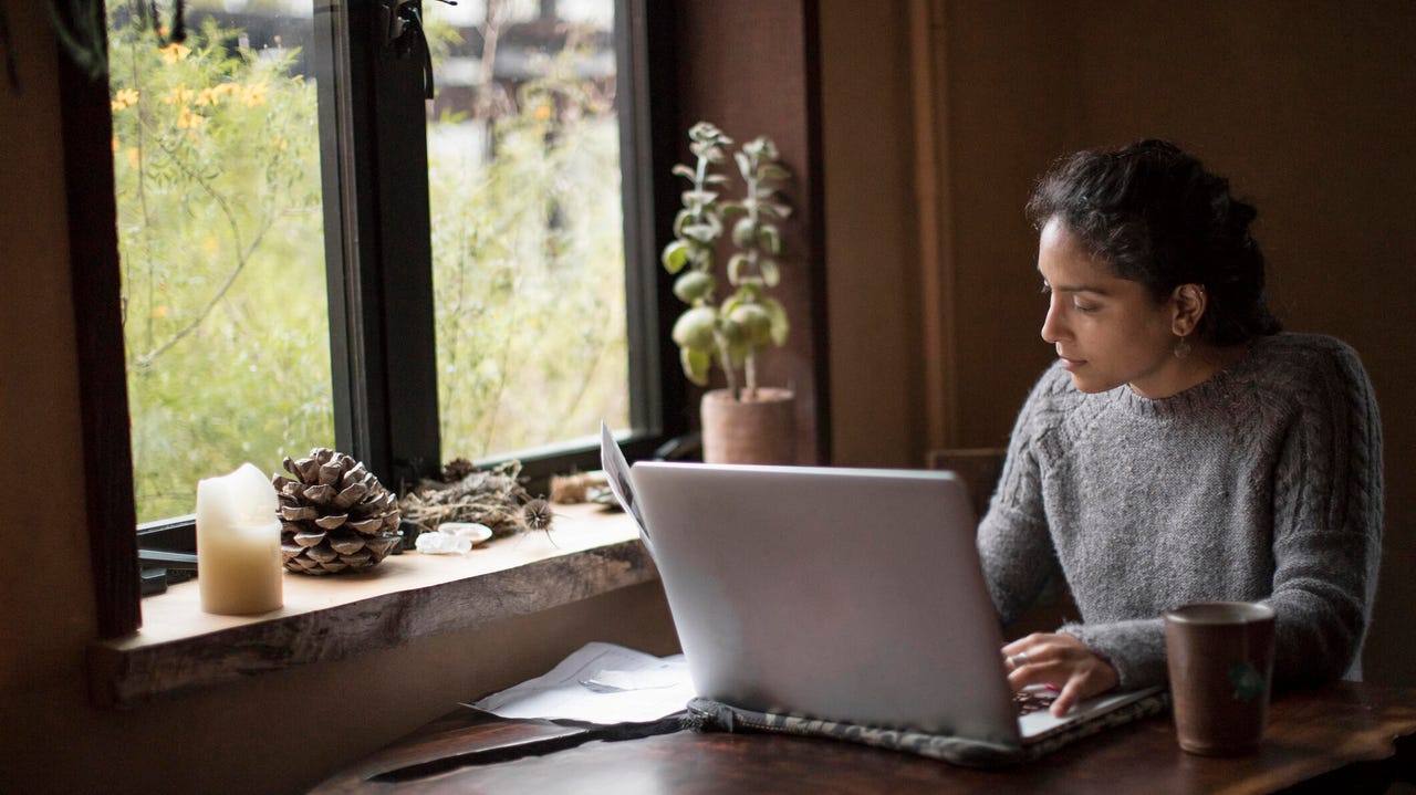 A woman using a laptop while working from home. 