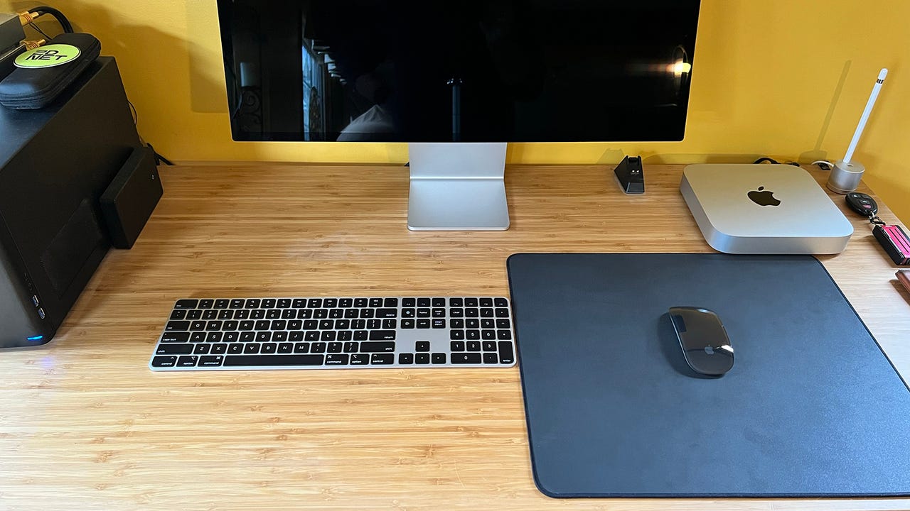 An M2 Mac Mini with various Apple Peripherals on a desk