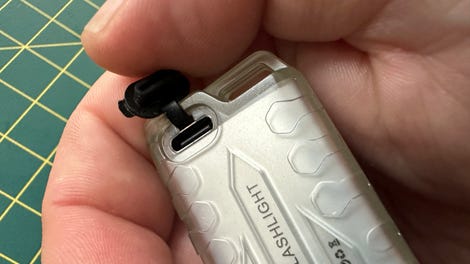 A rubber bung covers the USB-C charging port to prevent water and dirt from entering.