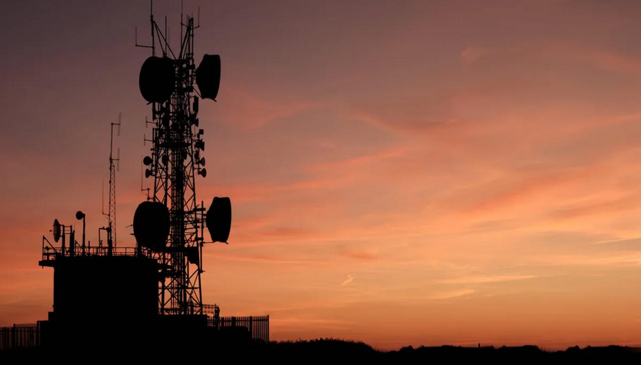 A cell tower against a sunset