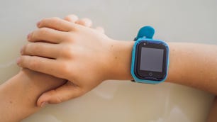 Close up of a kid's arm with a blue smartwatch on it