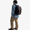 Man wearing a backpack facing opposite direction