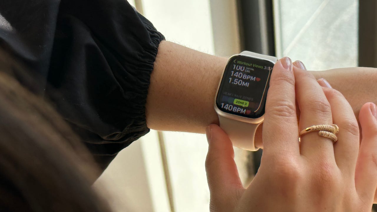 focused in shot of a young woman scrolling through the workout view of an Apple Watch Series 8