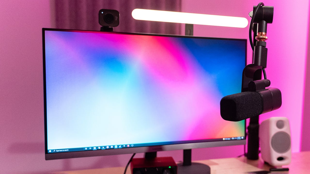 Logitech Litra key light and Blue Sona XLR mic with a monitor on a desk.