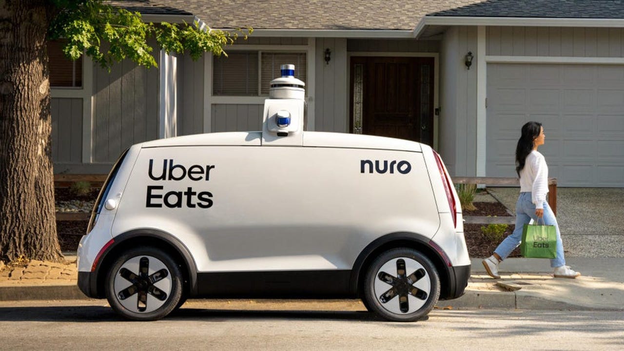 Nuro electric vehicle delivering Uber Eats outside of someone's house.