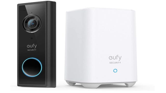A black Eufy video doorbell next to a white Eufy hub