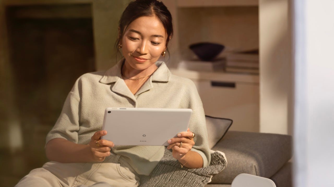 A woman holding the Pixel Tablet.