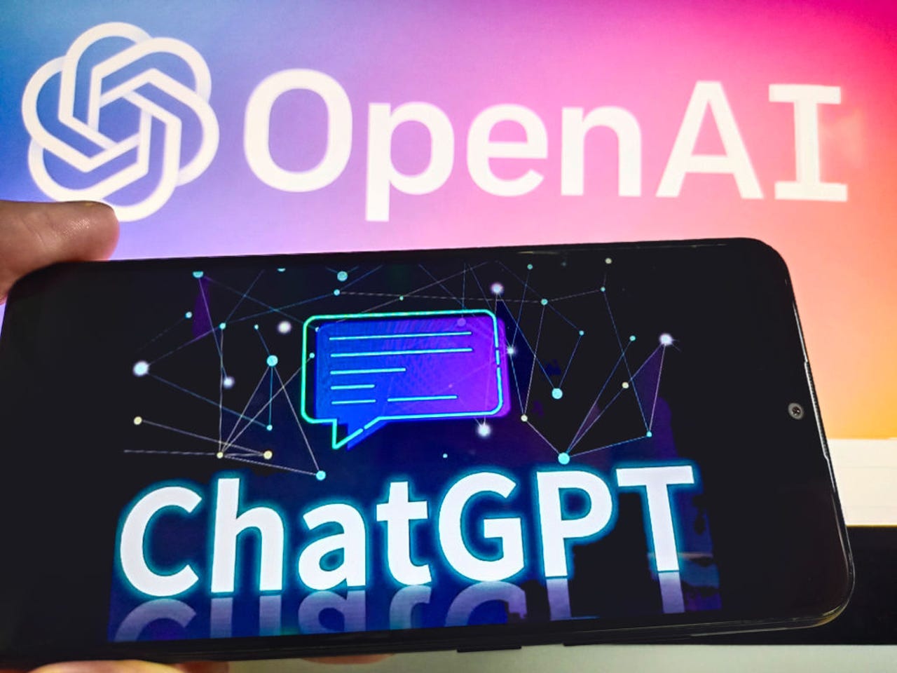 OpenAI in background and ChatGPT logo on phone
