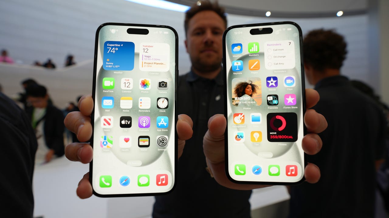 A person holding up two iPhones