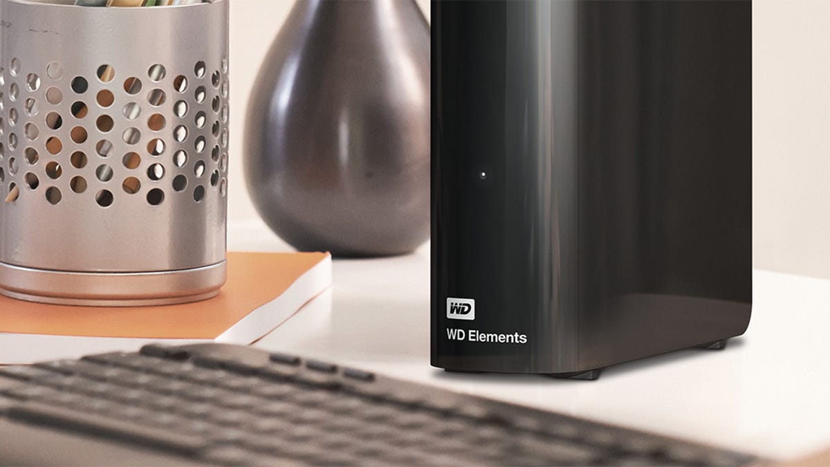 Partial view of a WD Elements 16TB external hard drive on a desk next to a computer keyboard