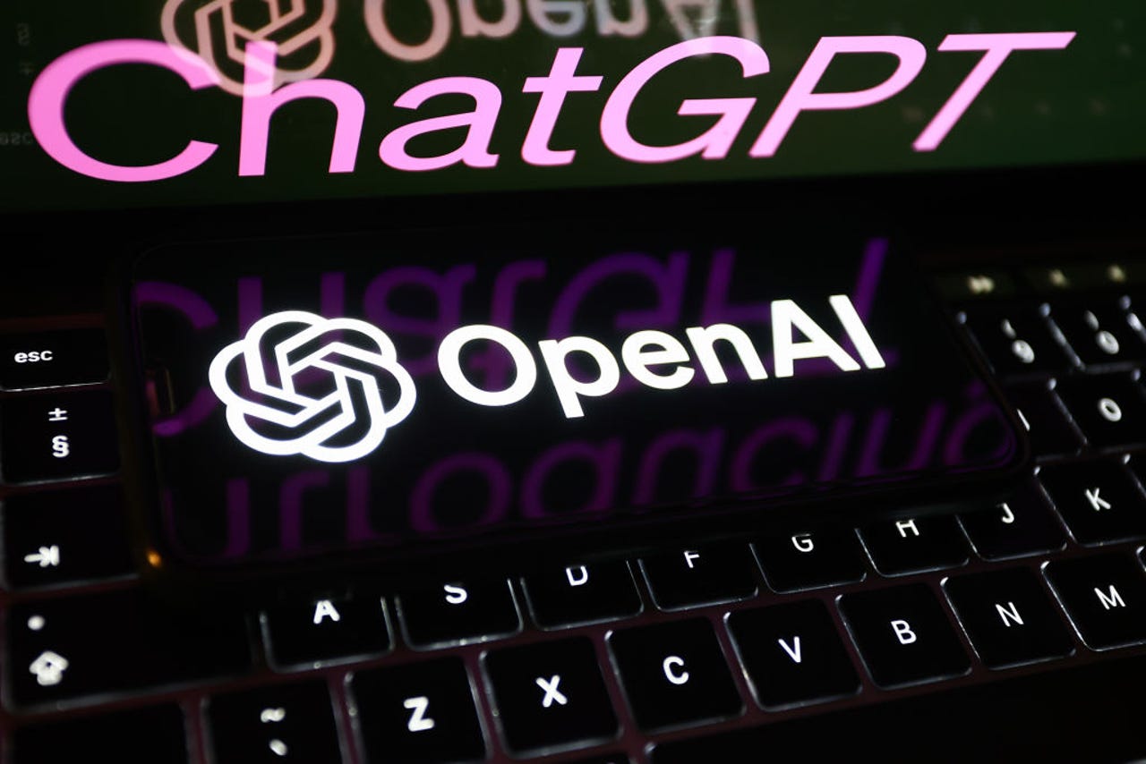 ChatGPT on laptop screen and OpenAI on phone that is on a keyboard