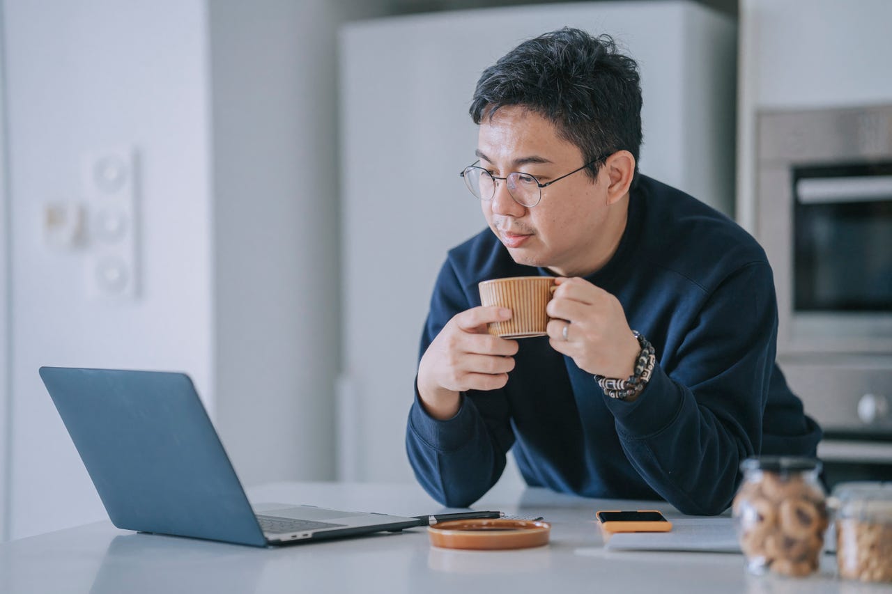 Man working at home using laptop stock photo