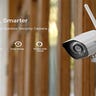 A Zmdo security camera mounted to a wall next to a set of french doors.