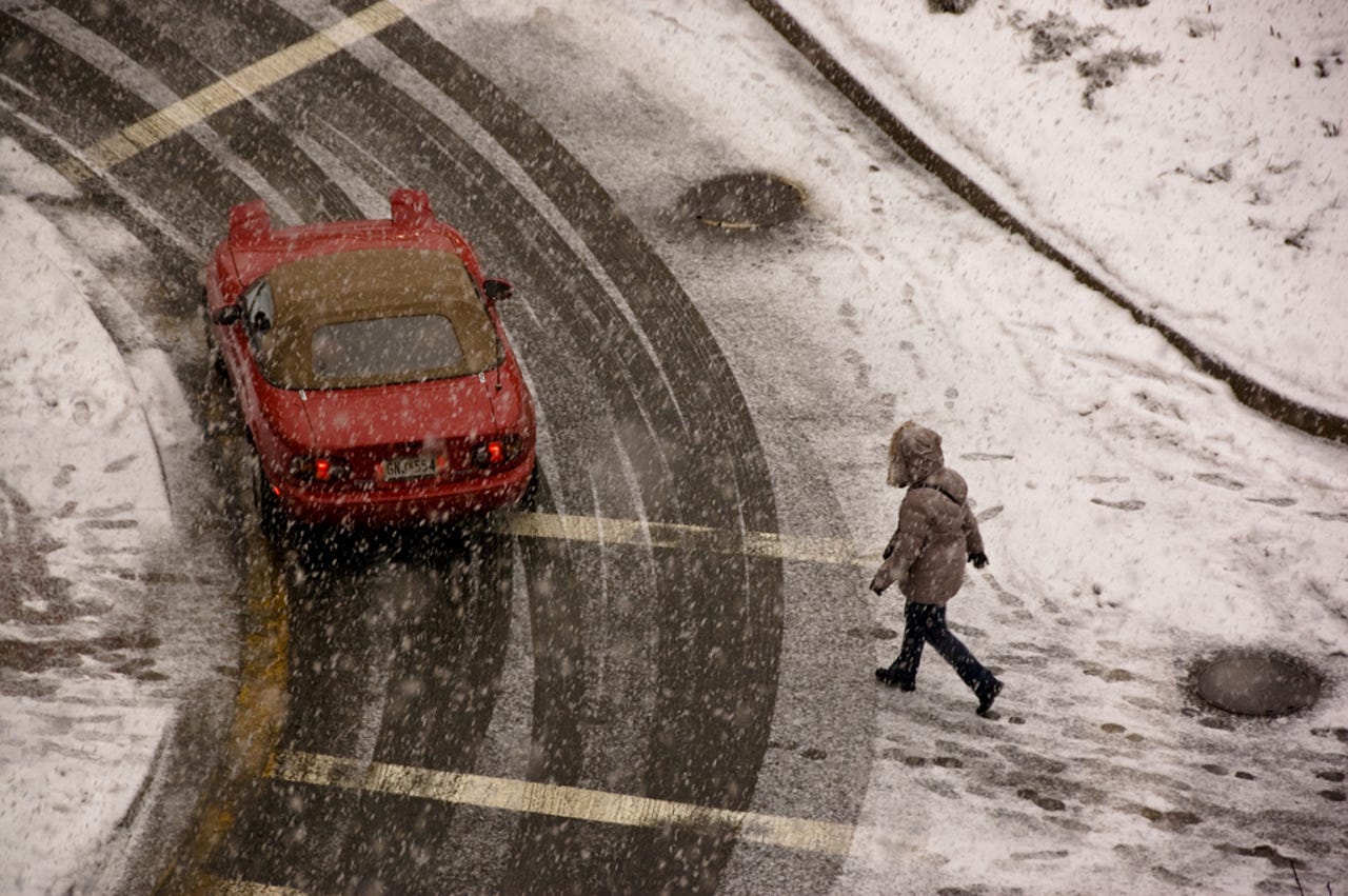 pedestrian-walking-car-turning-snow-flickr.jpg