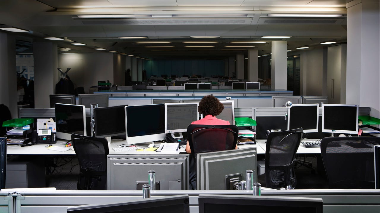A business woman working late in an empty office - stock photo